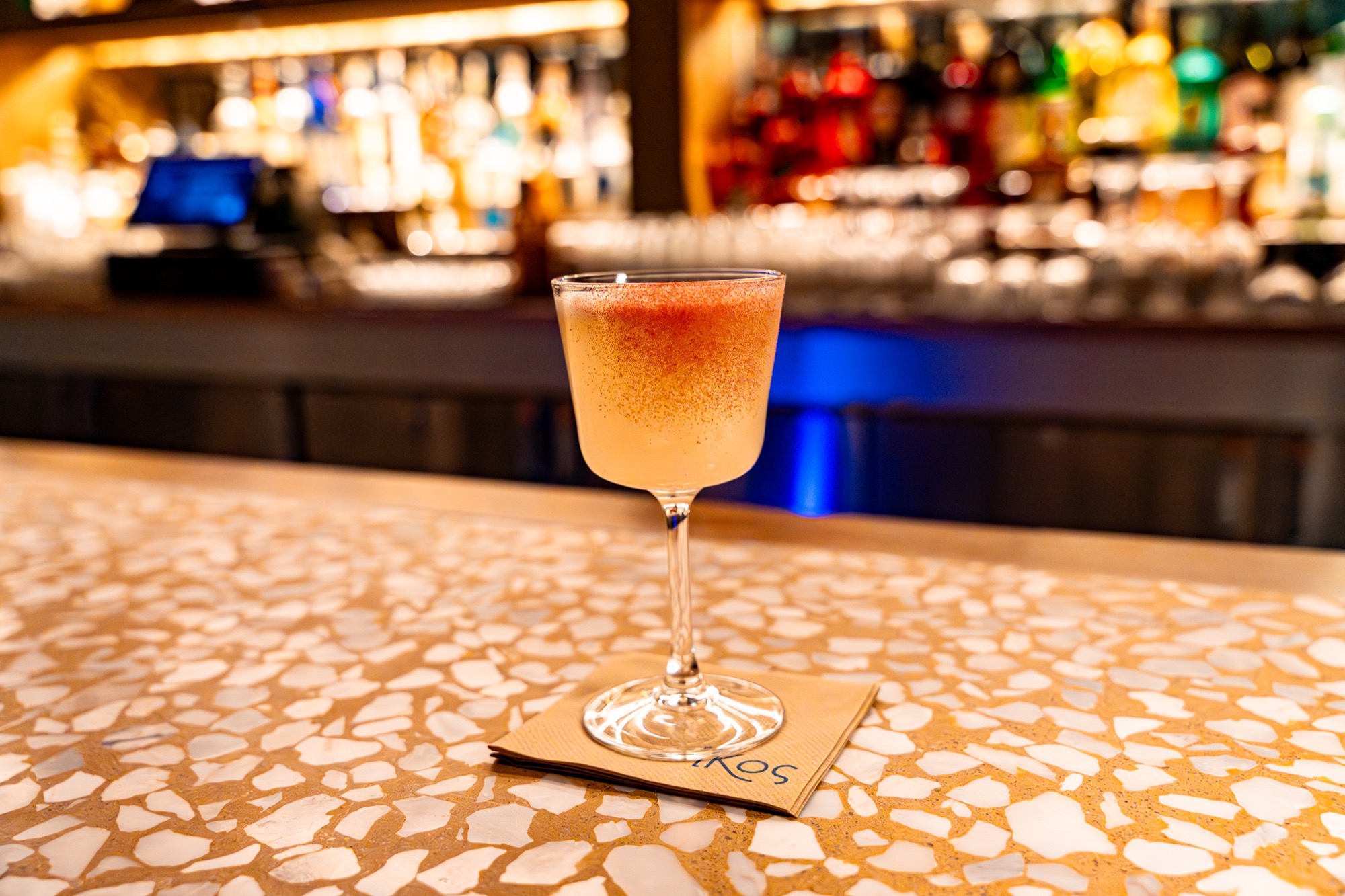 A cocktail glowing at the IKOS bar