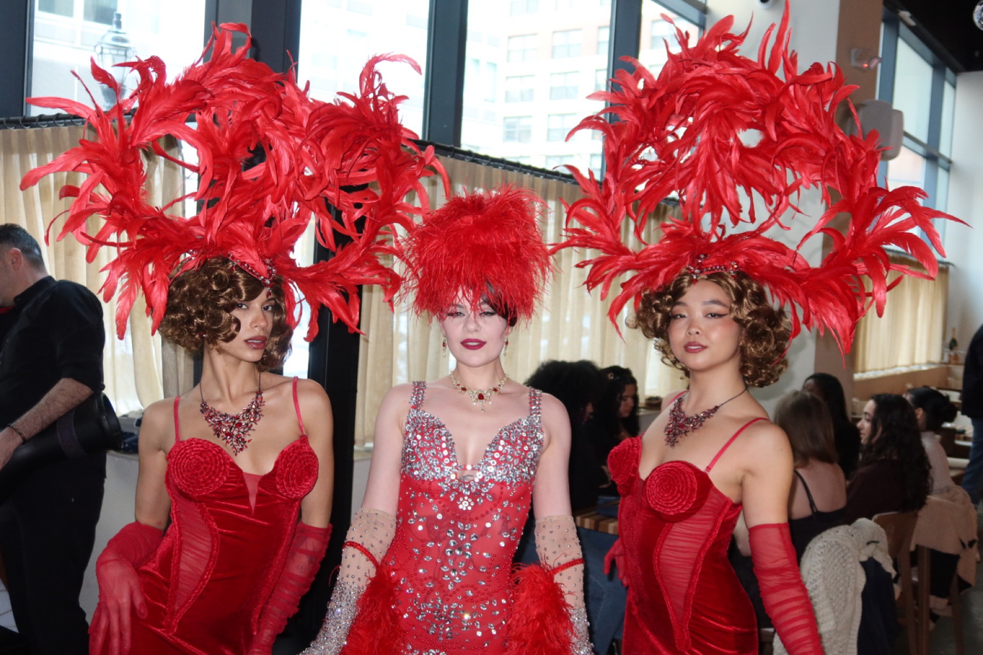 Performers in red at an IKOS event