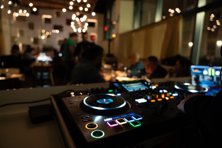 The IKOS dining room after dark with the DJ booth lit