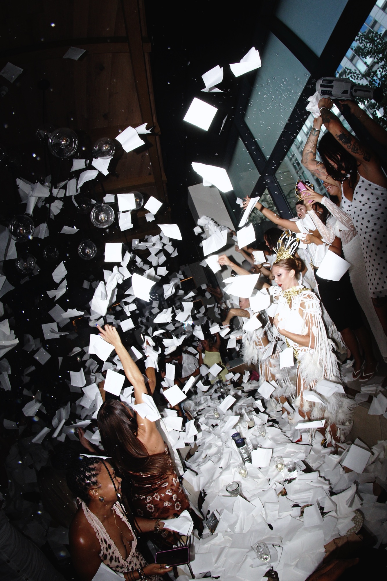 Guests tossing napkins in the air at the IKOS Party Brunch